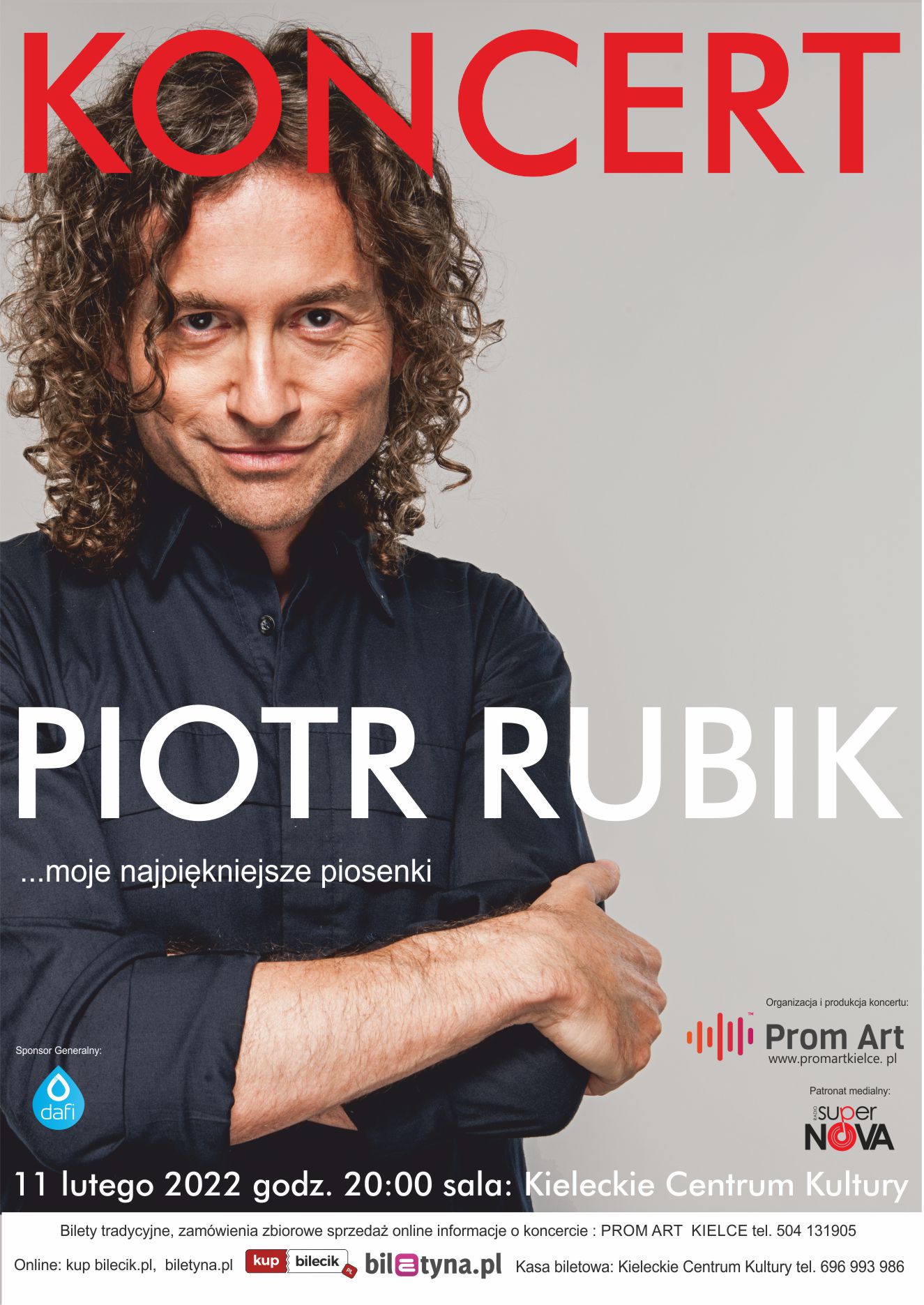 Grafika. Zdjęcie uśmiechniętego mężczyzny z ciemnymi dłuższymi włosami w delikatne loki. Na zdjęciu napis: koncert. Niżej: Piotr Rubik. Moje najpiękniejsze piosenki. 11 lutego 2022 godz. 20. sala: Kieleckie Centrum Kultury.