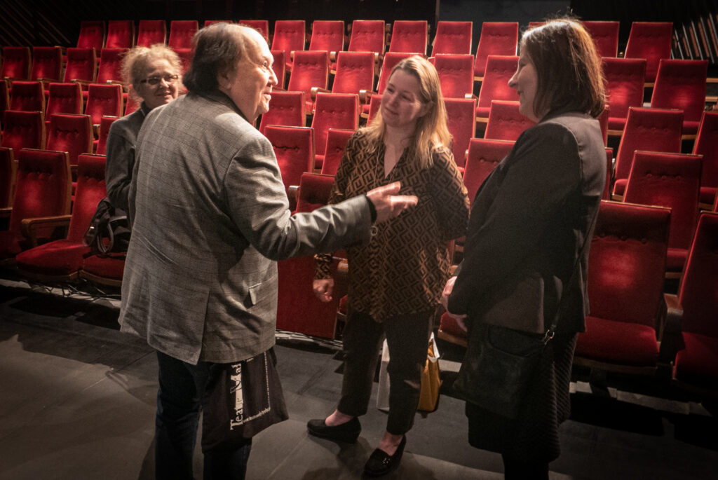 Zdjęcie. Krzysztof Miklaszewski rozmawia z dwoma kobietami po seansie na Małej Scenie KCK.