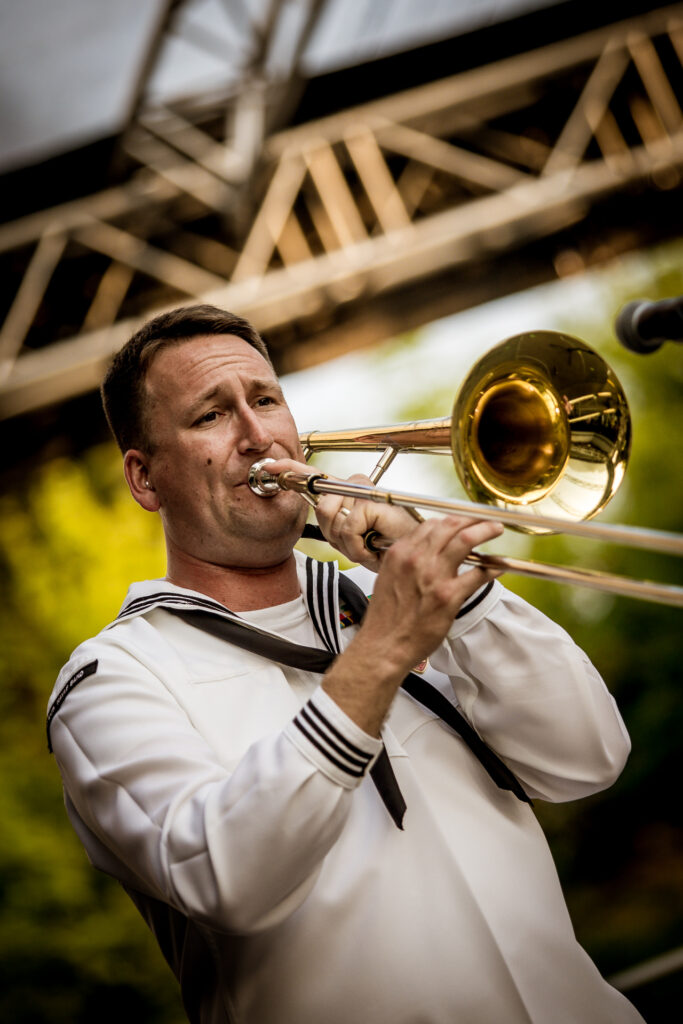 Zdjęcie. Muzyk zespołu TopSide Band gra na puzonie.